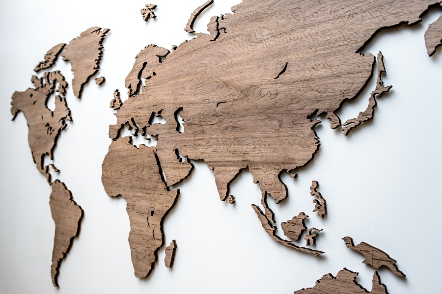Wooden world map with country names and pins on the wall Nut, Map it Studio